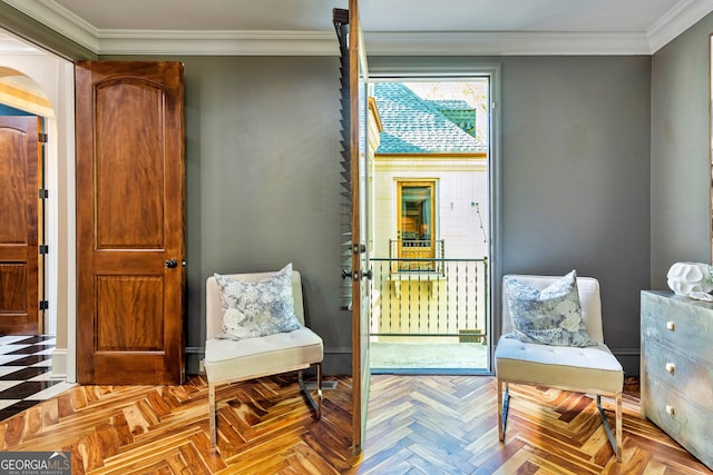 living area with ornamental molding and light parquet floors