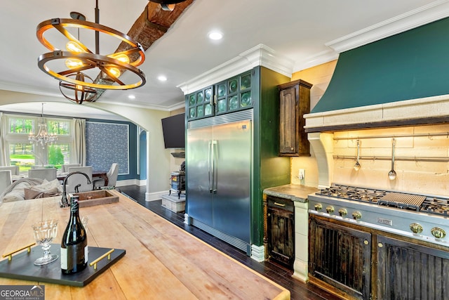 kitchen featuring crown molding, a notable chandelier, dark hardwood / wood-style flooring, and built in fridge