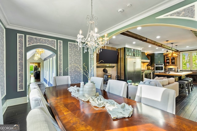 dining area featuring ornamental molding, sink, and dark hardwood / wood-style flooring