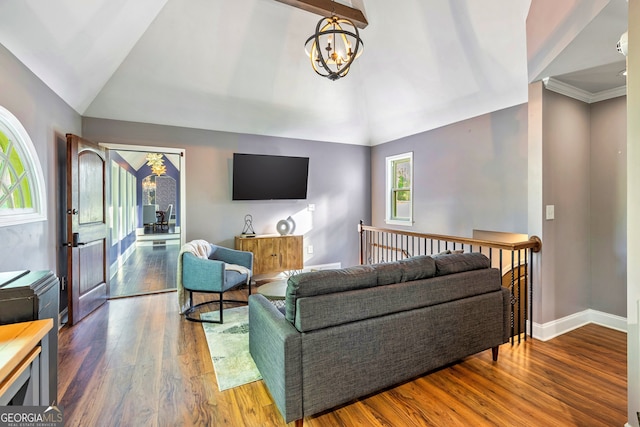 living room with vaulted ceiling with beams, wood-type flooring, and plenty of natural light