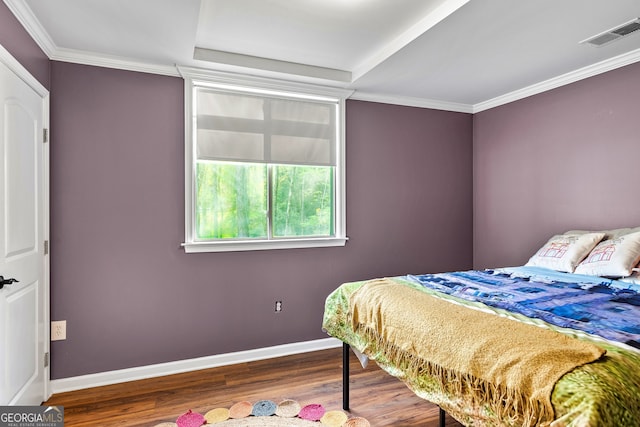 bedroom featuring ornamental molding and hardwood / wood-style flooring