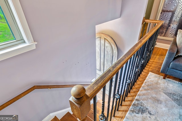 stairs featuring wood-type flooring