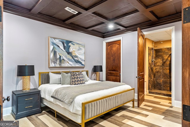 bedroom featuring connected bathroom, coffered ceiling, and light hardwood / wood-style flooring