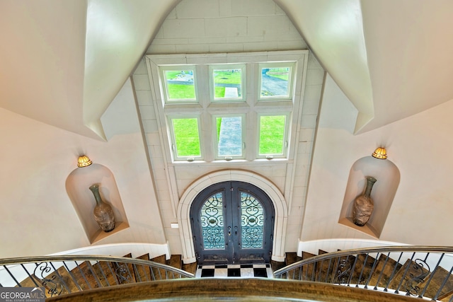 entrance foyer with french doors and a towering ceiling