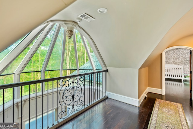 additional living space featuring lofted ceiling and dark hardwood / wood-style floors