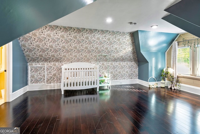 additional living space with lofted ceiling and hardwood / wood-style flooring