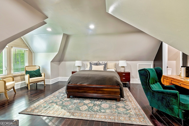 bedroom with lofted ceiling and dark hardwood / wood-style floors