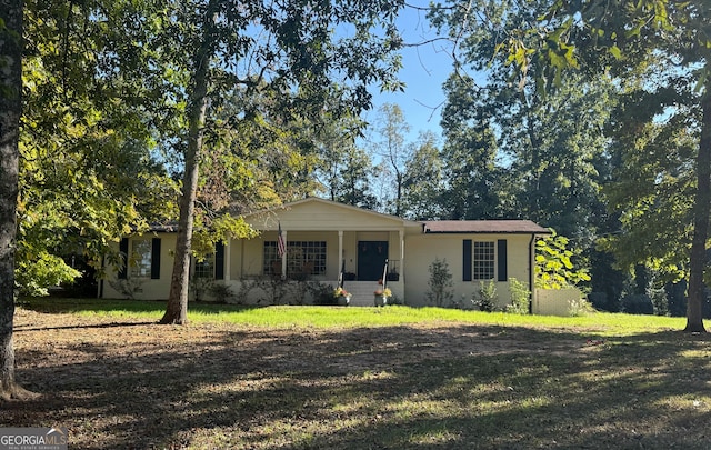 ranch-style house with a porch and a front lawn