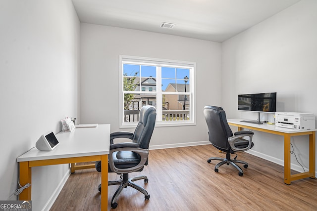 office space with light wood-type flooring