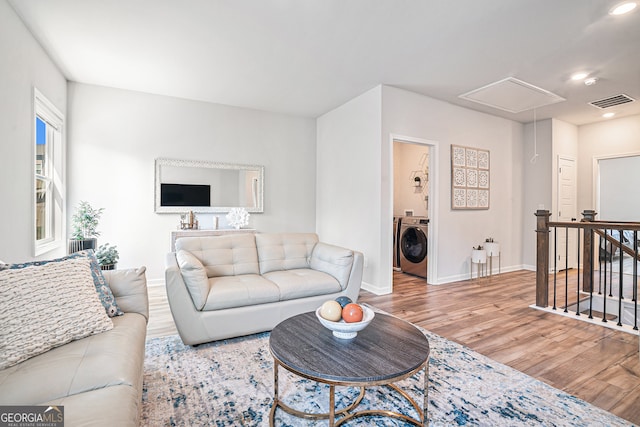 living room featuring washer / clothes dryer and hardwood / wood-style flooring