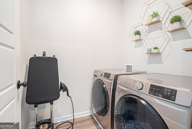 washroom featuring hardwood / wood-style flooring and independent washer and dryer