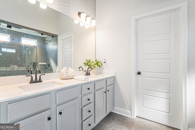 bathroom featuring tile patterned flooring, a shower with door, and vanity