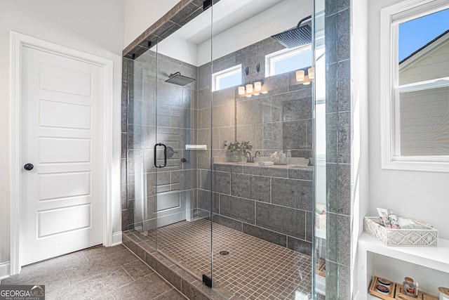 bathroom featuring walk in shower, tile patterned flooring, and a healthy amount of sunlight