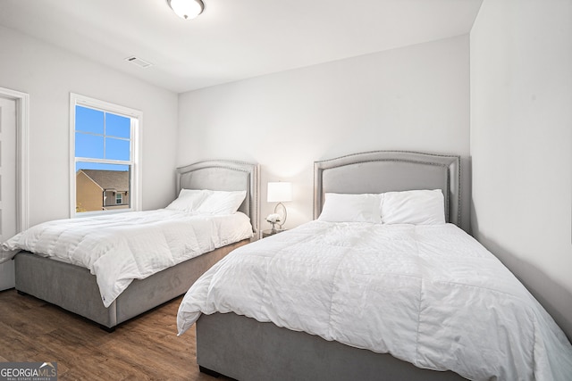 bedroom featuring dark hardwood / wood-style flooring