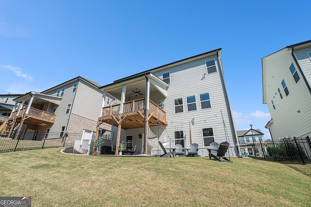 rear view of house featuring ceiling fan, a balcony, a yard, and a patio