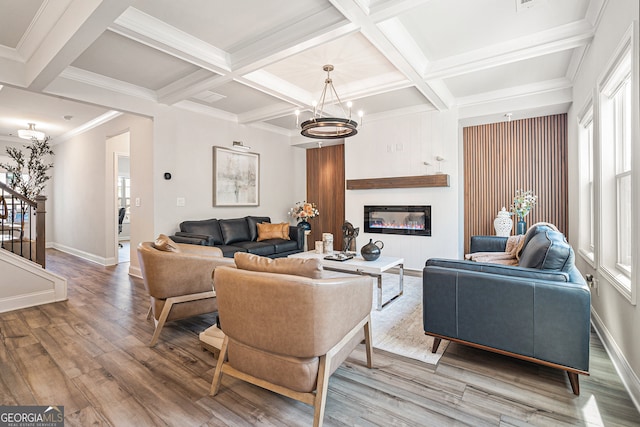 living room featuring coffered ceiling, beamed ceiling, light hardwood / wood-style flooring, and plenty of natural light