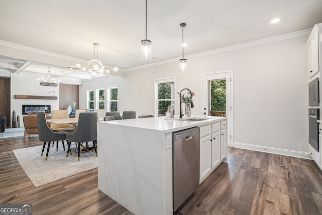 kitchen featuring pendant lighting, stainless steel dishwasher, a center island with sink, dark wood-type flooring, and white cabinetry