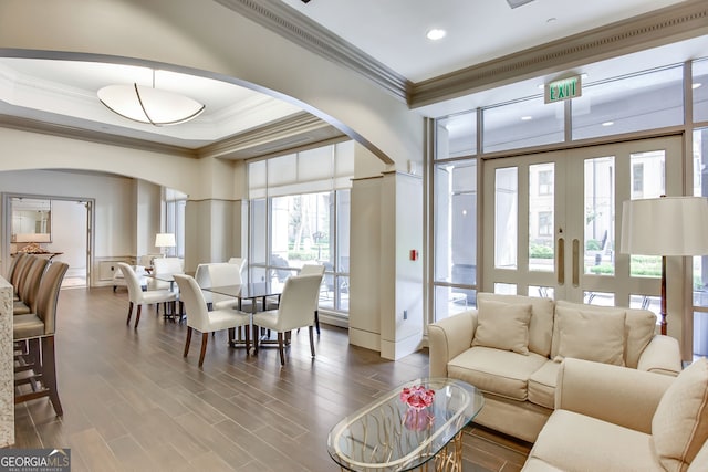 living room with french doors, crown molding, and hardwood / wood-style floors