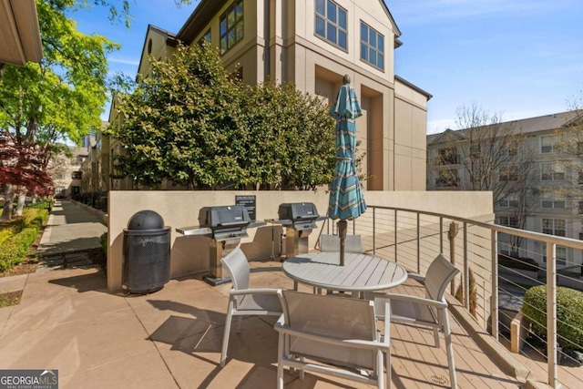 view of patio with a balcony, area for grilling, and exterior kitchen