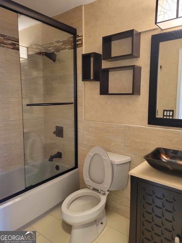 full bathroom with enclosed tub / shower combo, vanity, tile patterned flooring, and toilet