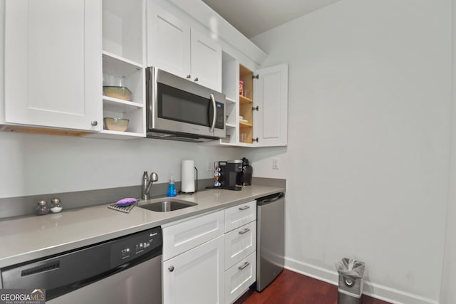 kitchen featuring stainless steel appliances, dark hardwood / wood-style floors, white cabinets, and sink