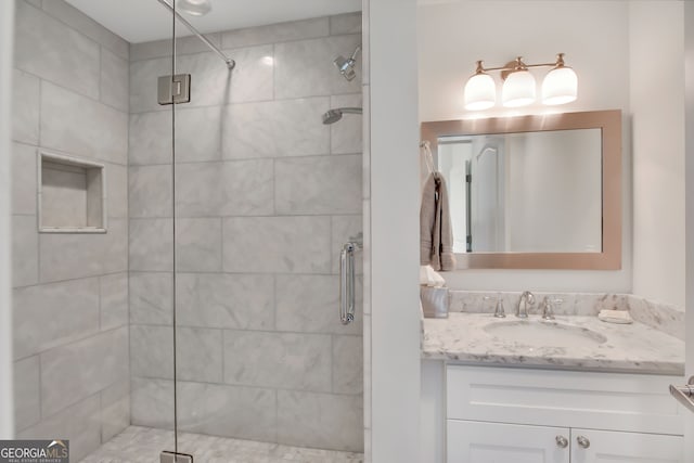 bathroom featuring an enclosed shower and vanity