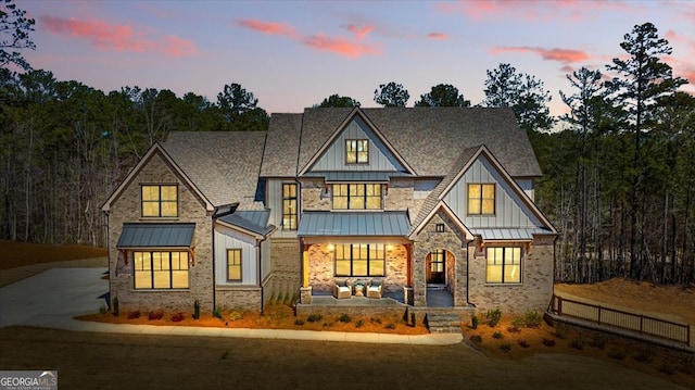612 Forest Pointe Dr, Forsyth, GA 31029 - view of front of property featuring a standing seam roof, board and batten siding, covered porch, and a shingled roof