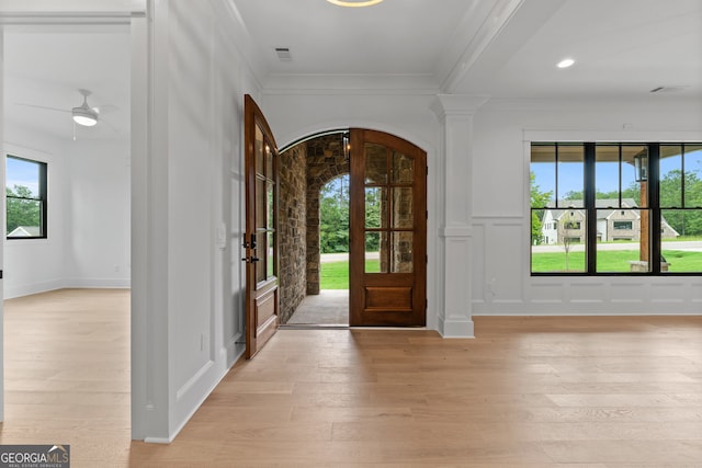 entryway with ceiling fan, light hardwood / wood-style flooring, decorative columns, and ornamental molding