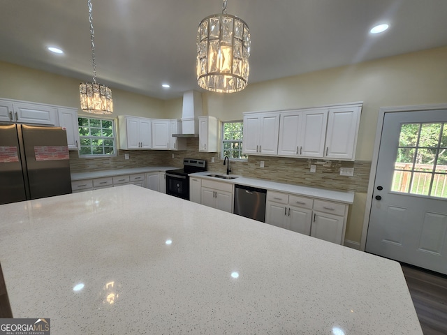 kitchen with stainless steel appliances, white cabinets, and a healthy amount of sunlight