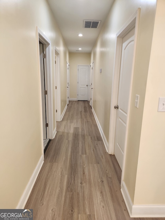 hallway with light wood-type flooring