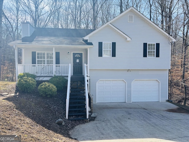 split level home featuring a garage and covered porch