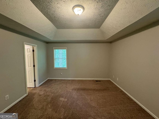 carpeted spare room with a textured ceiling