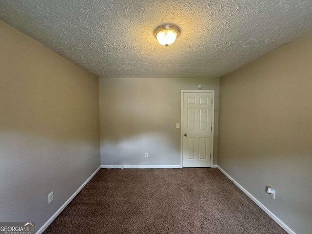 empty room featuring carpet floors and a textured ceiling