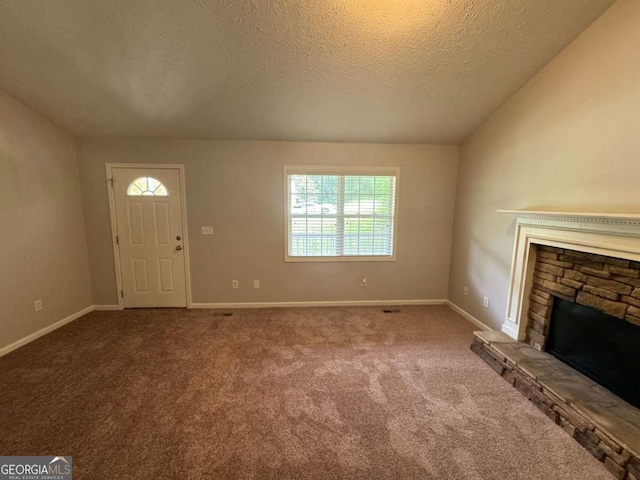 unfurnished living room featuring vaulted ceiling, carpet, and a wealth of natural light