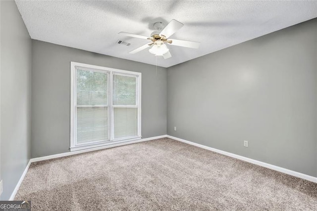 unfurnished room with a textured ceiling, ceiling fan, and carpet flooring