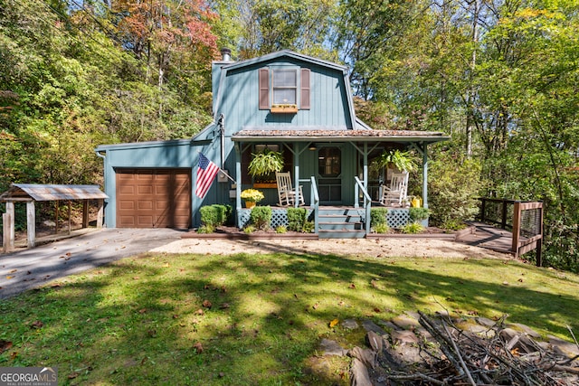 view of front facade with a porch, a front yard, and a garage