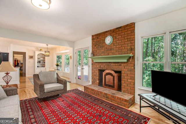 living room with light hardwood / wood-style flooring and a healthy amount of sunlight