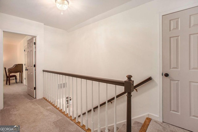 hallway featuring light carpet