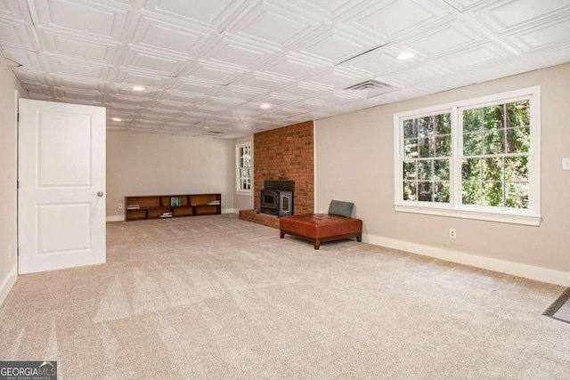 carpeted living room with a wood stove