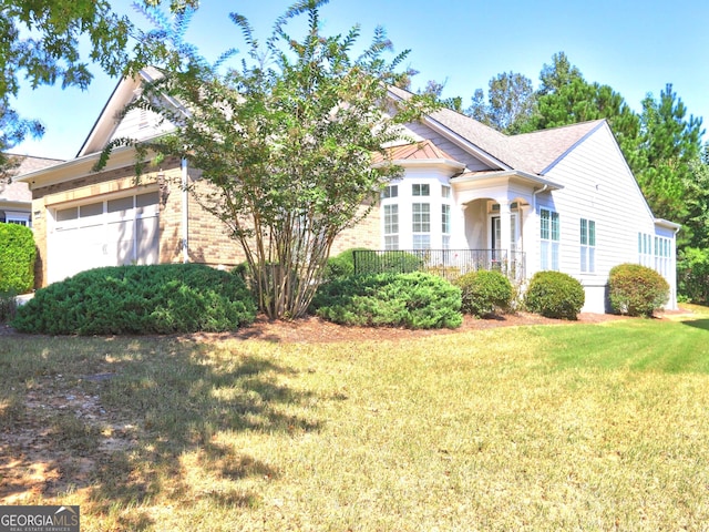 view of front of home featuring a front yard and a garage