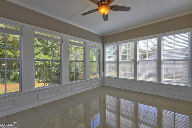 unfurnished sunroom with ceiling fan