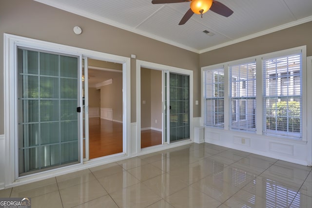 unfurnished sunroom with ceiling fan