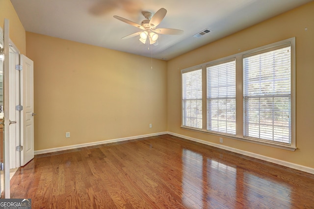 unfurnished room with ceiling fan and wood-type flooring