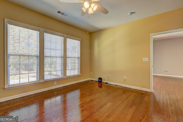 spare room with light wood-type flooring and ceiling fan