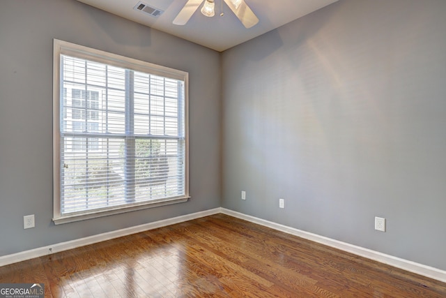 spare room featuring wood-type flooring and ceiling fan