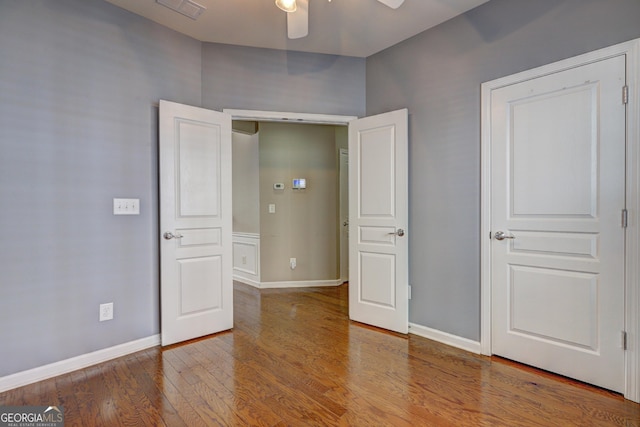 unfurnished bedroom featuring hardwood / wood-style floors and ceiling fan