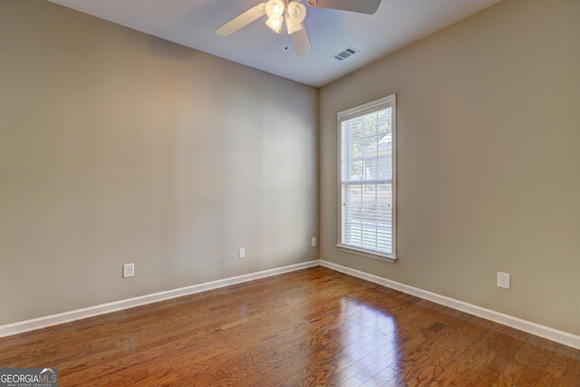 spare room with ceiling fan and wood-type flooring