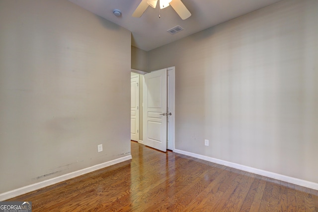 spare room with hardwood / wood-style flooring and ceiling fan