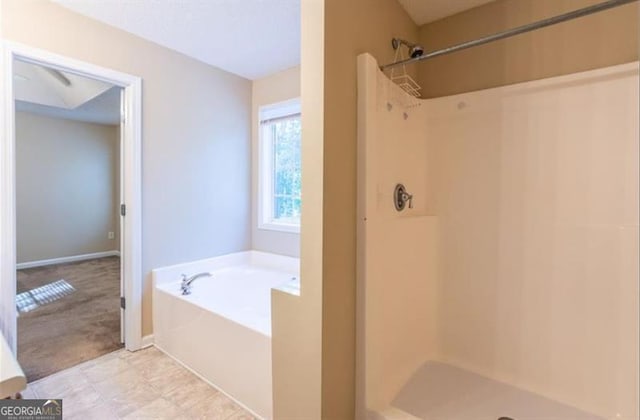 bathroom with separate shower and tub