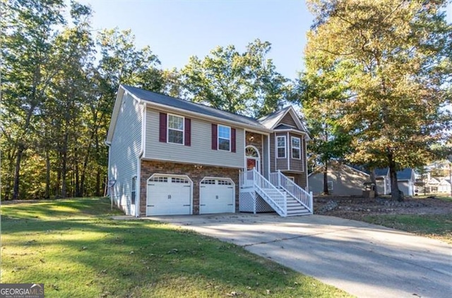 bi-level home with a garage and a front lawn